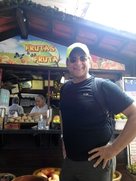 A person preparing food while standing in front of a store Description automatically generated