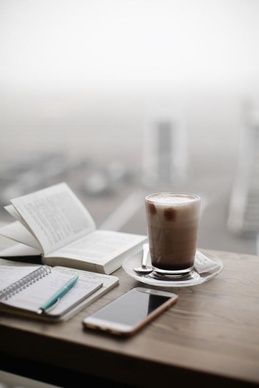A cup of coffee on a table Description automatically generated